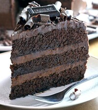 foto de um bolo de chocolate com camadas e cobertura de ganache de chocolate preto